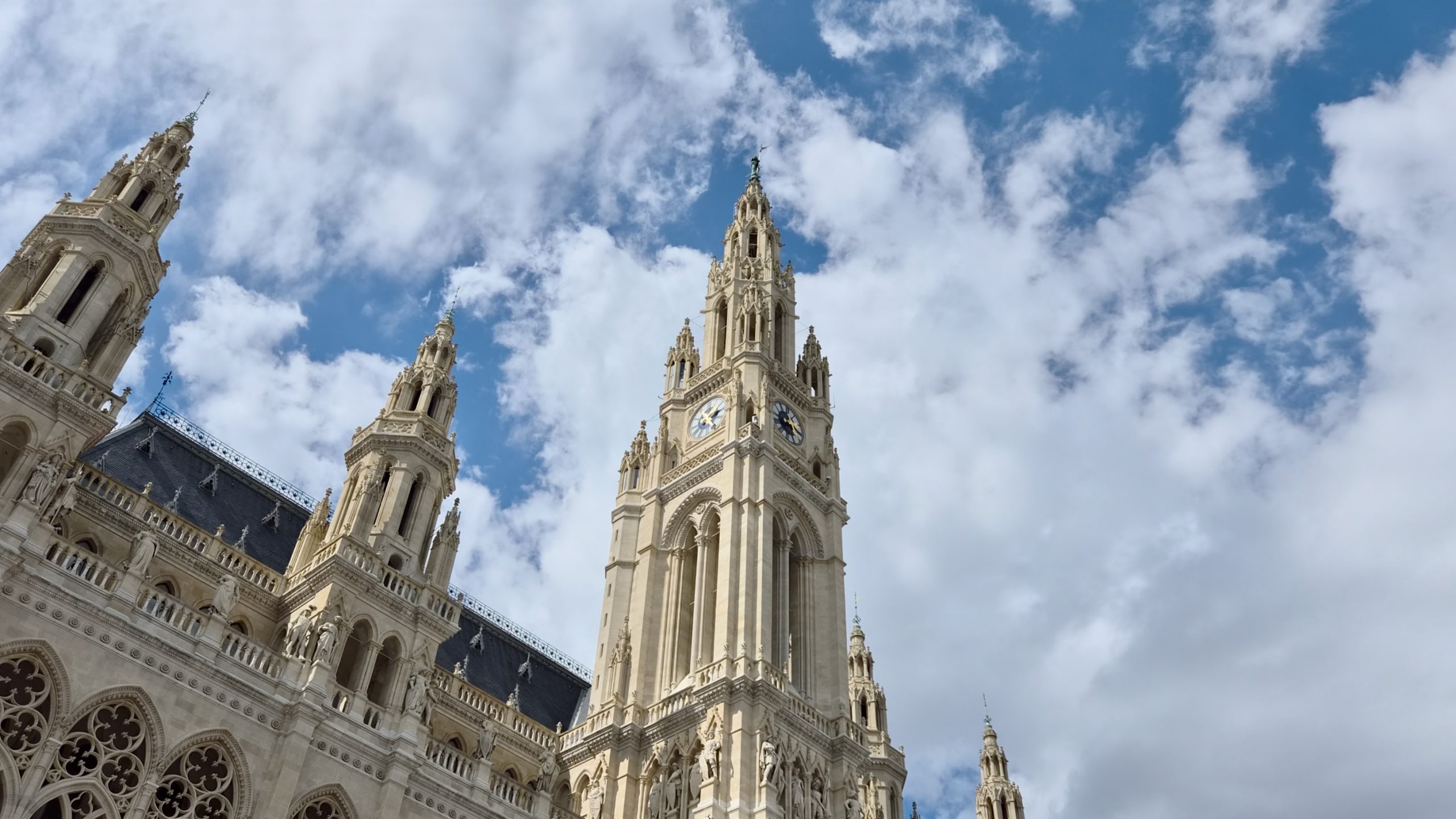 The neo-Gothic spires of Vienna's Rathaus against a cloudy sky